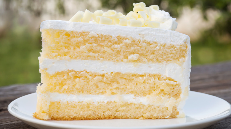 slice of white layered cake with white icing