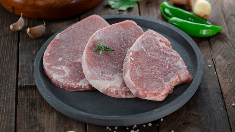 Three frozen veal steaks on a plate