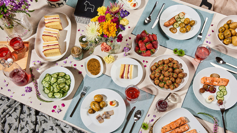 Table spread of food, drinks, and flowers