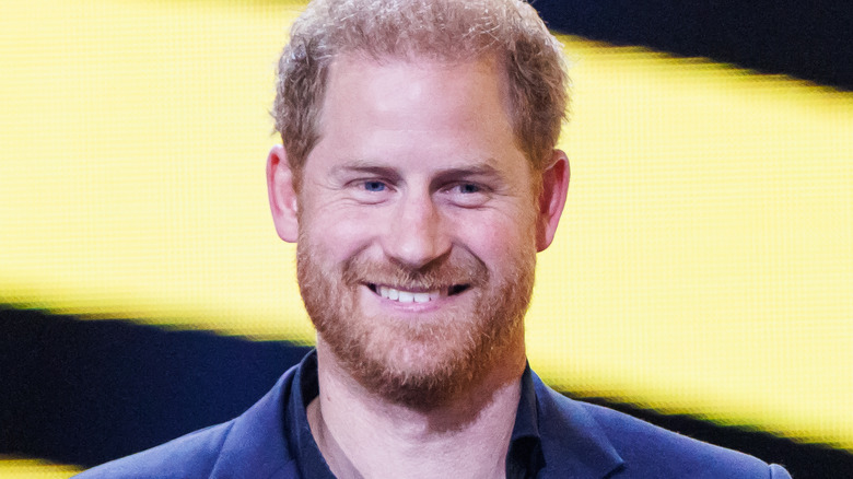 Prince Harry smiles in blue blazer