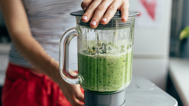 making a smoothie with spinach