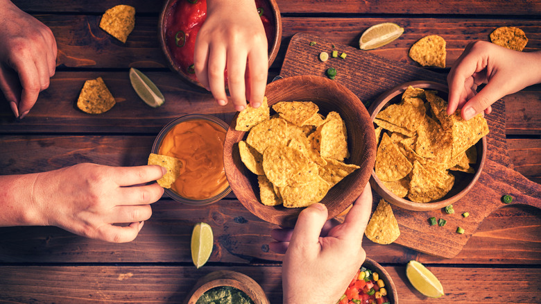 People sharing chips and dips