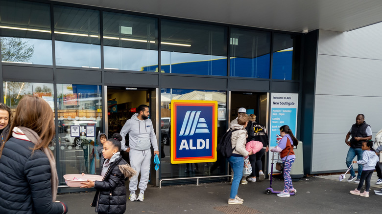 people walking in and out of aldi