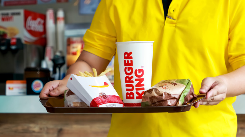 person carrying Burger King tray
