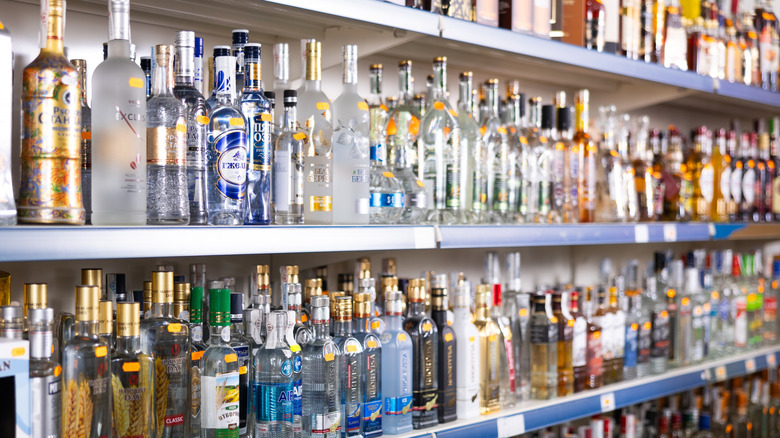 Grocery store aisle with multiple brands of alcohol in bottles