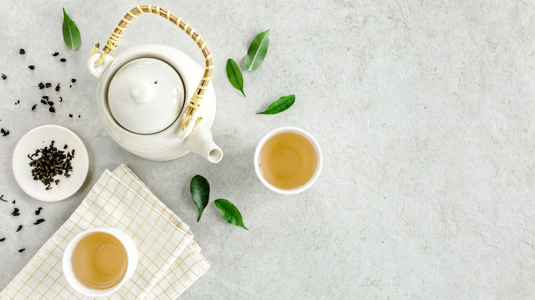 white tea set with two cups of herbal tea