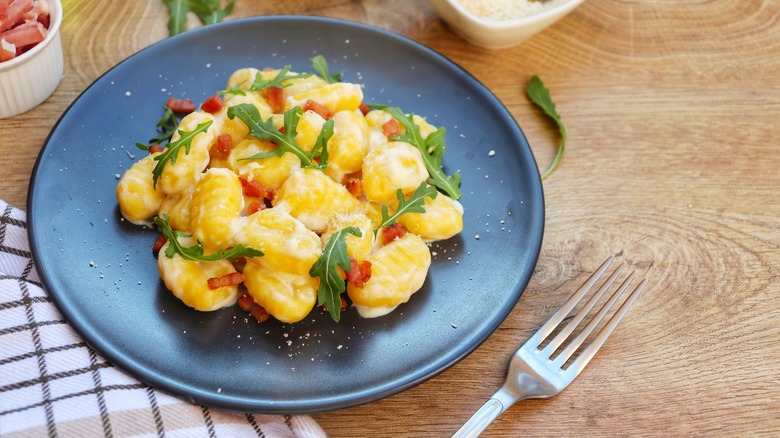 Plate of gnocchi on table
