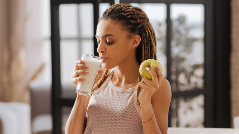 Fit woman drinking a glass of milk