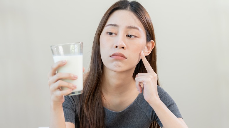 woman holding glass milk