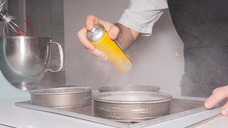 person using cooking spray