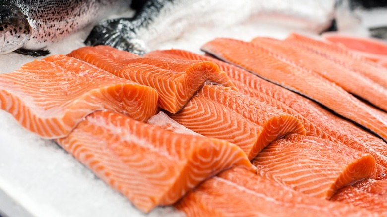 raw salmon filets on ice