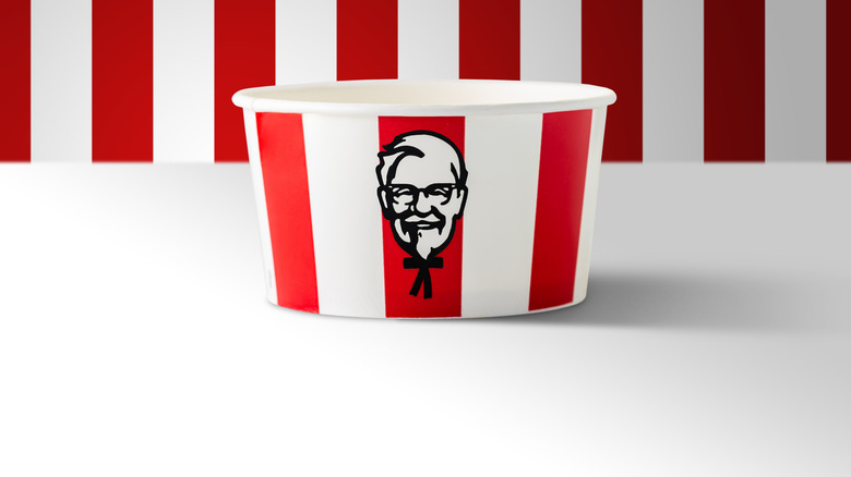 A kfc bucket on a red an white background