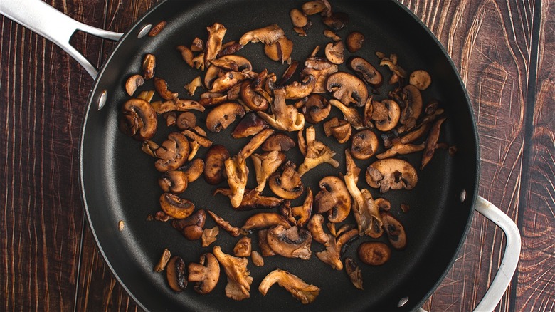 Satueed mushrooms in frying pan 
