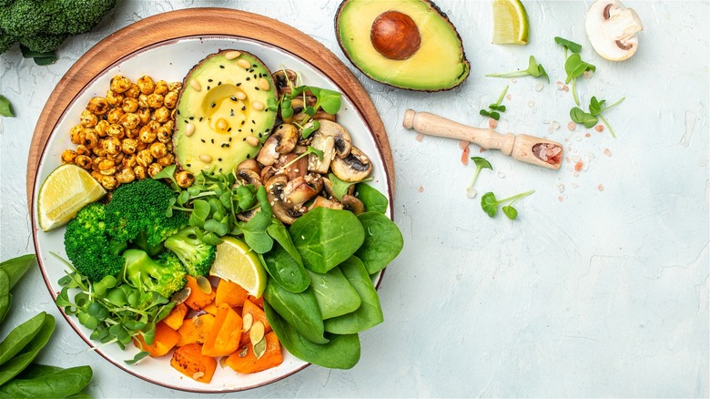 Raw and cooked vegetables with avocado 