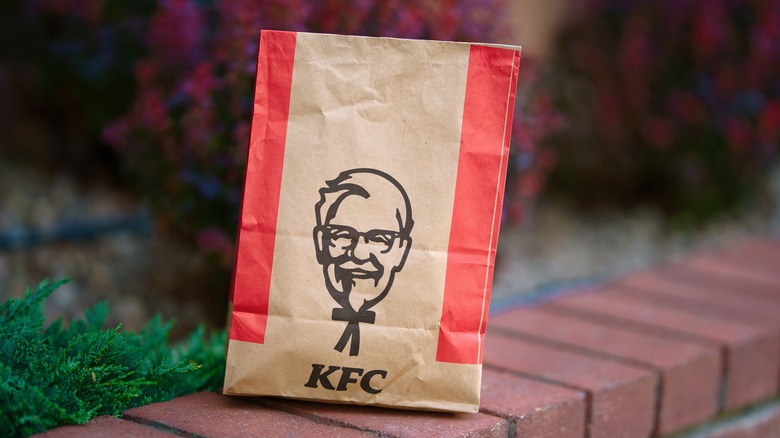 Paper KFC bag, sitting on an outdoor wall