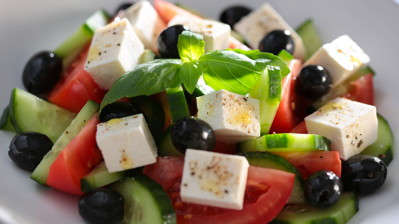 Greek salad with basil garnish