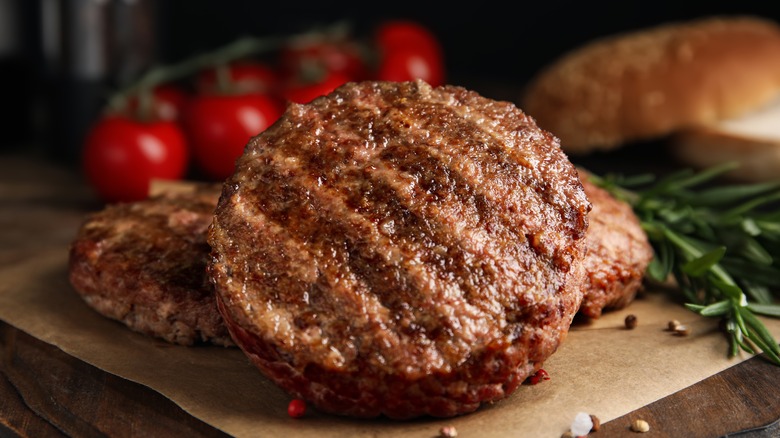 cooked burger patties on a board