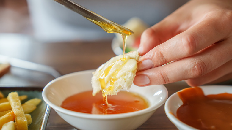 knife dripping jam onto egg