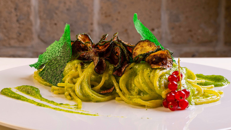 Spaghetti alla Nerano on white platter with garnish