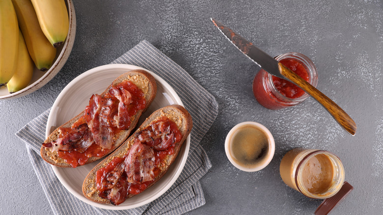 Peanut butter, jelly and bacon sandwich on a plate