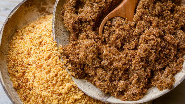 Light and dark brown sugar in wood bowls