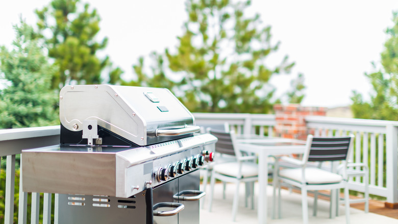 a gas grill with the lid closed on patio