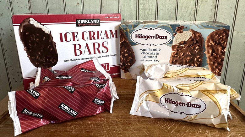 Kirkland ice cream bars with chocolate flavored coating and roasted almonds next to haagen-dazs vanilla milk chocolate almond ice cream bars