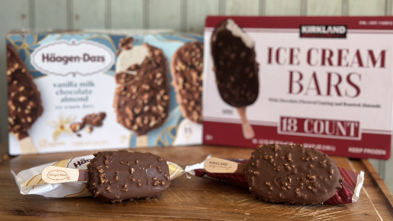 A kirkland chocolate covered ice cream bar next to the haagen-dazs brand version