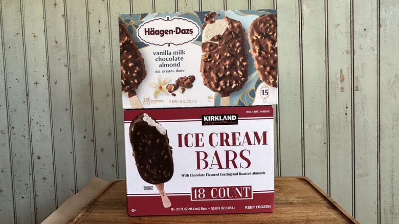 Haagen-Dazs vanilla milk chocolate almond bars box next to a box of Costco's Kirkland store brand