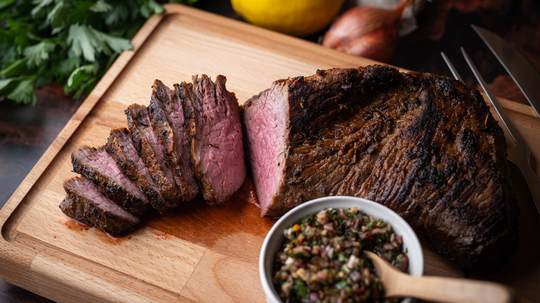 steak sliced on a wooden serving board