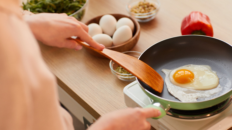 frying an egg in a pan