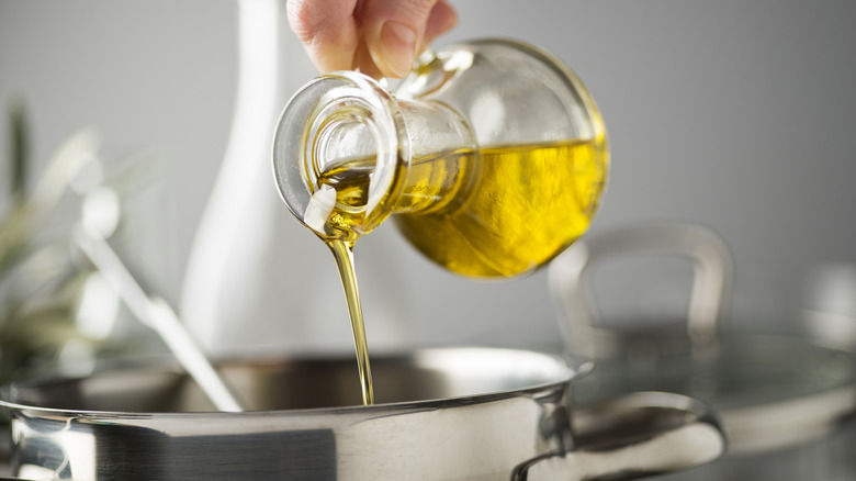 pouring olive oil into pot