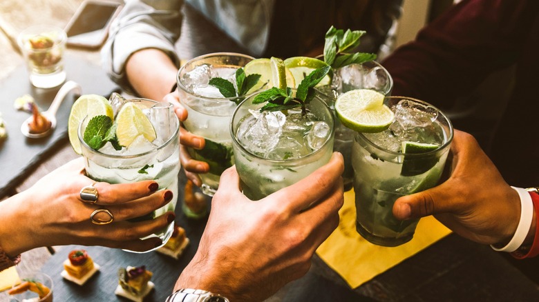 group holding mojitos