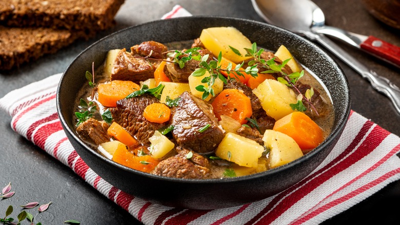 Bowl of beef stew on a tea towel