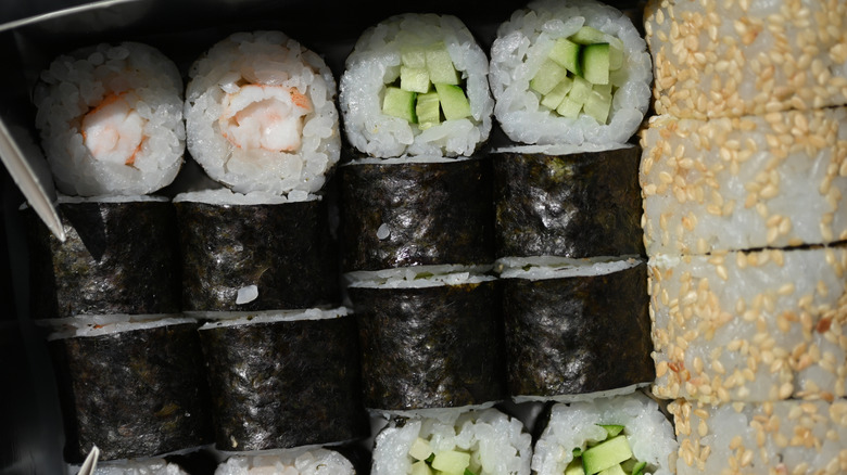 Close up of sushi rolls in a take out box