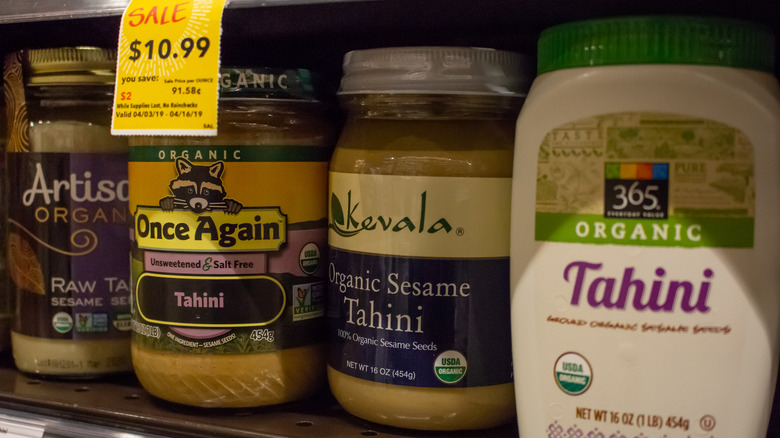 tahini jars on grocery store shelf