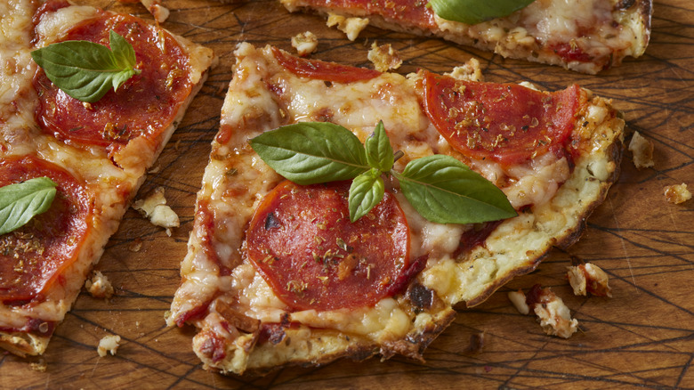 cottage cheese flatbread topped with tomato sauce, tomatoes, and basil