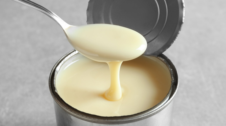 Evaporated milk spooned out of can