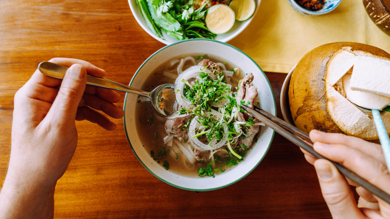 Vietnamese pho ga garnished with bean sprouts