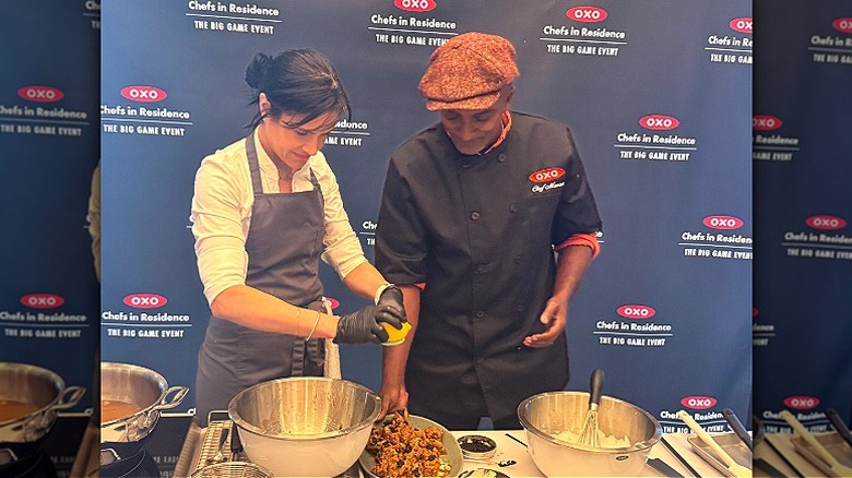 chef Marcus Samuelsson and chef Sherry Cardoso cooking fried chicken