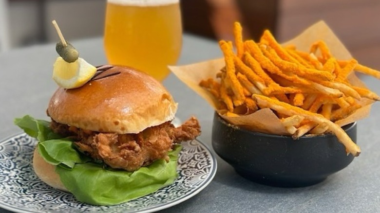 Cheese fries, fried chicken sandwich, and beer from Metropolis NYC