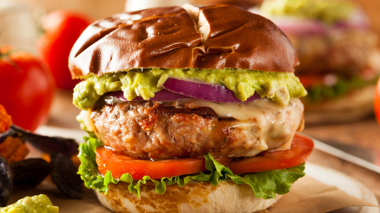 Turkey burger topped with guacamole