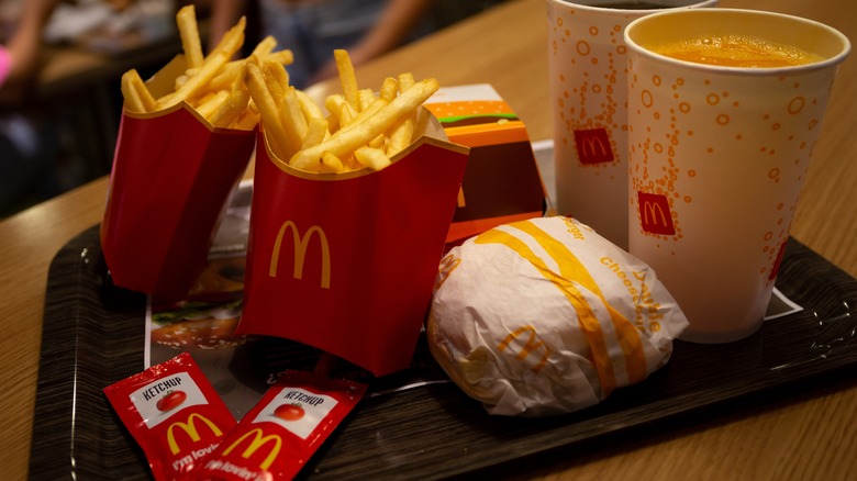 French fries, burgers, and sodas on a tray at a McDonald's joint