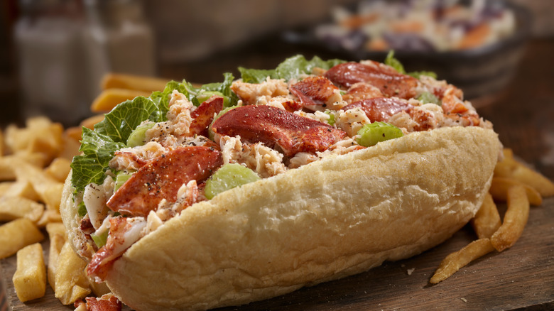 Lobster roll with salad dressing and lettuce with French Fries and Coleslaw