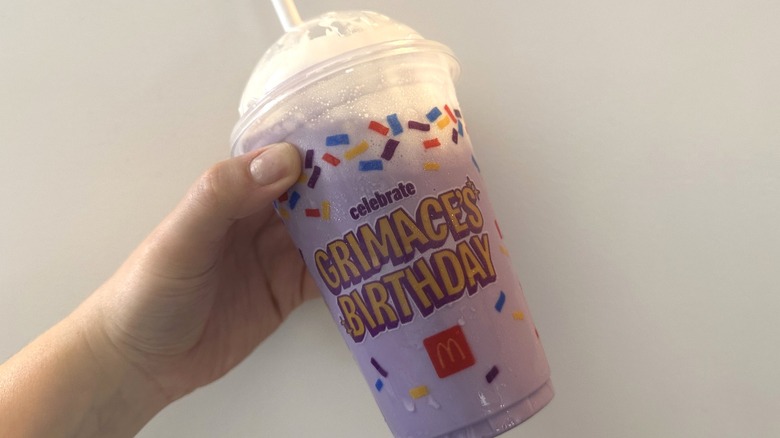 grimace birthday shake in hand