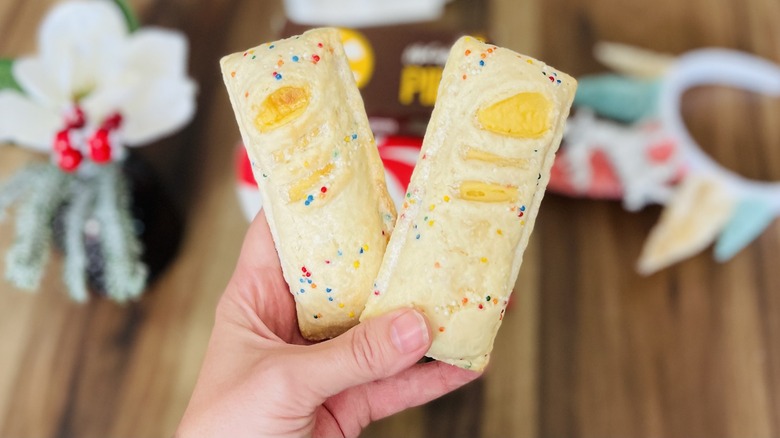 Hand holding two mcdonald's holiday pies