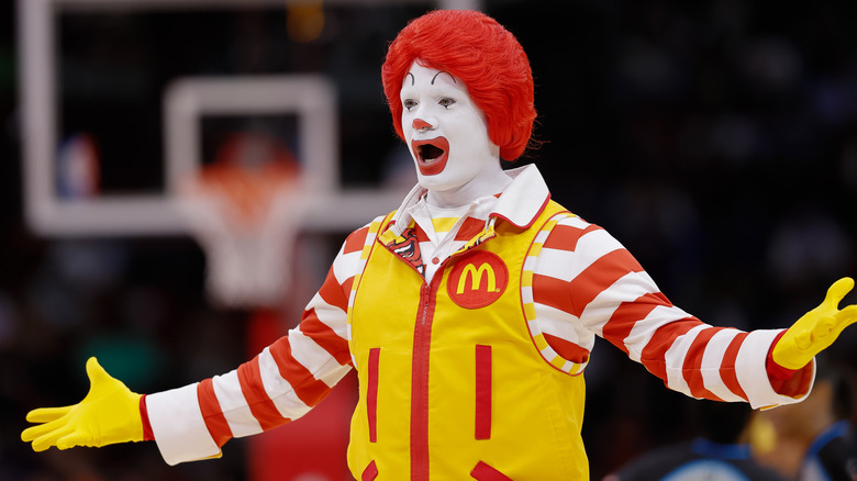 Ronald McDonald raising arms