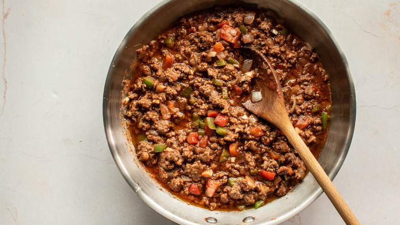 meat and veggies and sauce in a pan