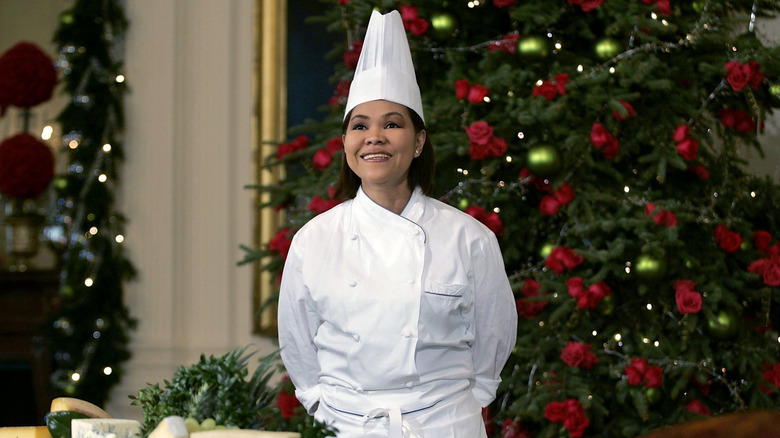 Chef Comerford stands in front of a holiday spread