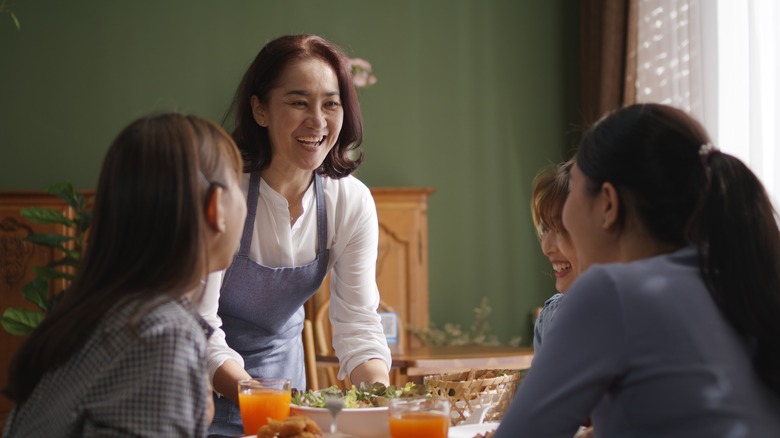 server presents a dish to a table